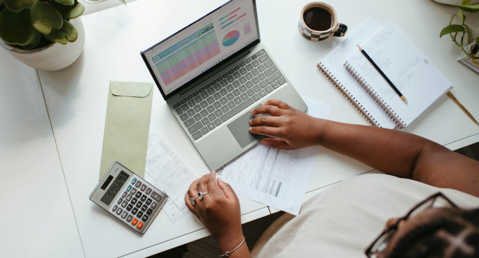 a person sitting at a table with a laptop