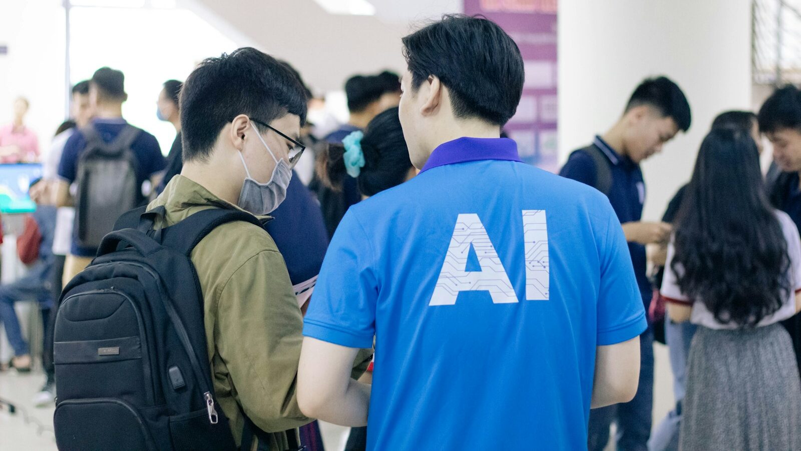 man in blue crew neck t-shirt standing near people